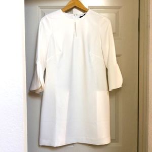 Never worn, beautiful white dress with bell sleeves.  Sleeves are clean